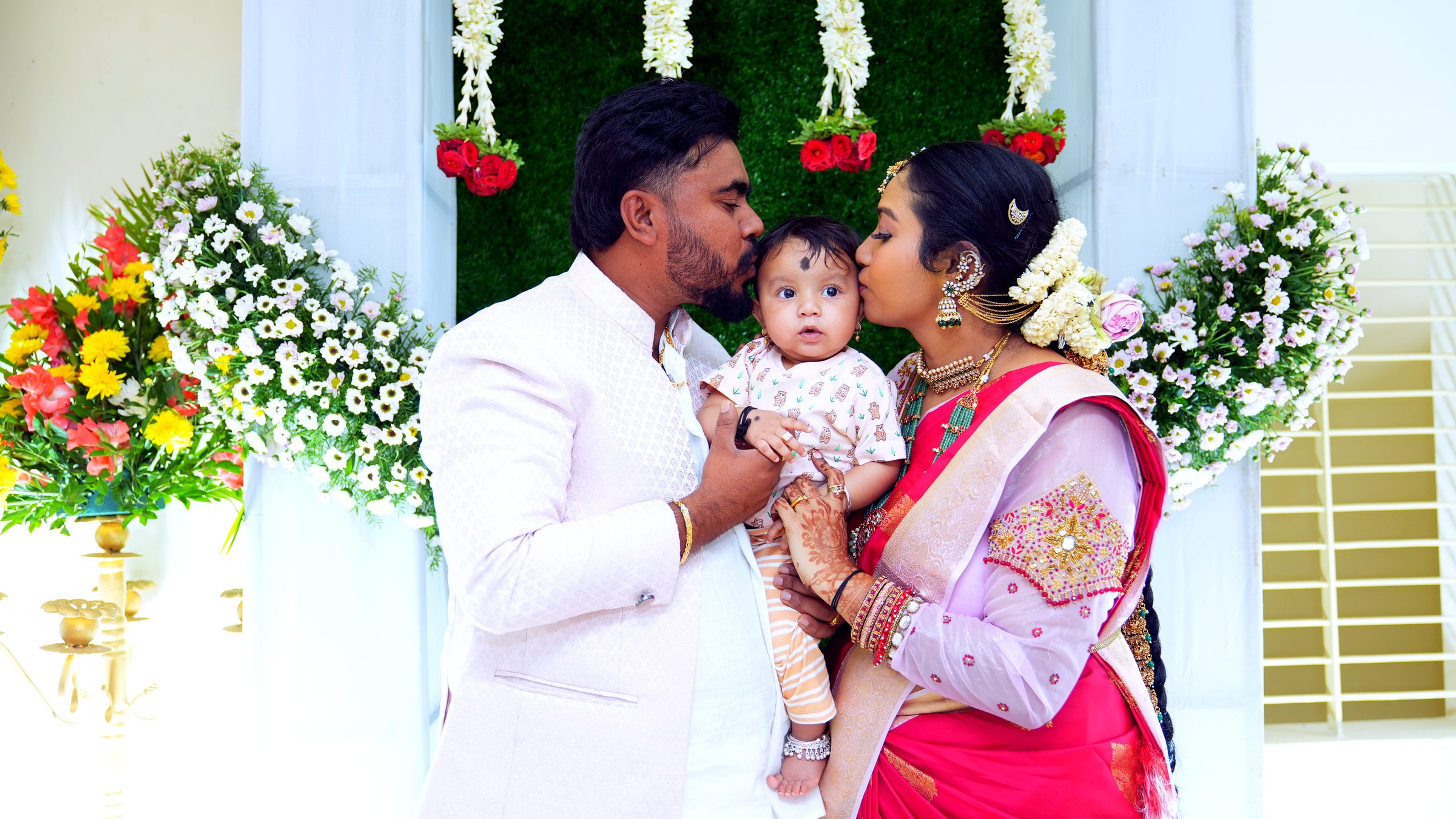 Tender close-up of a father holding his baby during the naming ceremony